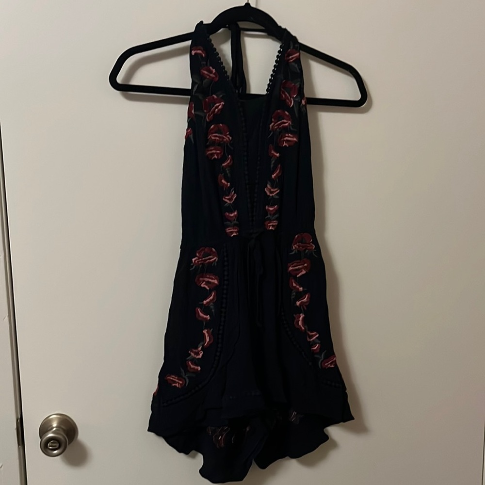 Black romper with dark pink flowers, size small